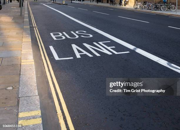 bus lane in a city street, london - bus lane stock pictures, royalty-free photos & images