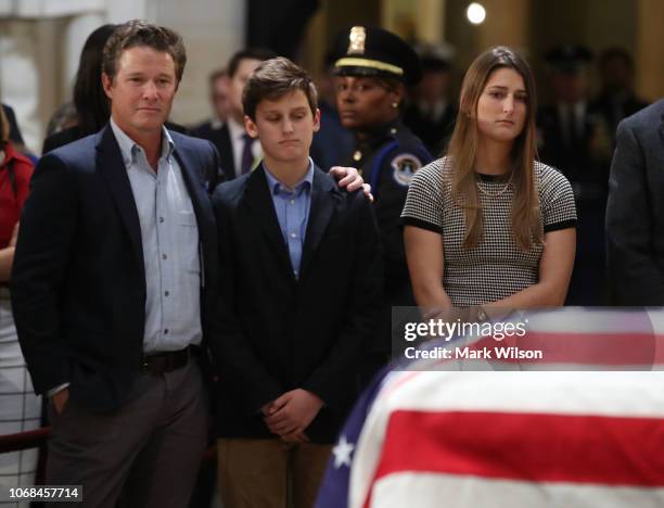 Billy Bush and Bush extended family members pay their respects in front of the casket of the late former President George H.W. Bush as he lies in...