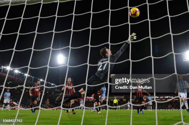 Terence Kongolo of Huddersfield Town scores his team's first goal past Asmir Begovic of AFC Bournemouth during the Premier League match between AFC...