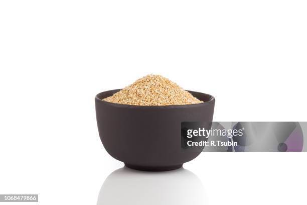 pile of grain quinoa seeds in bowl isolated over the white background - bowl of cereal stock pictures, royalty-free photos & images