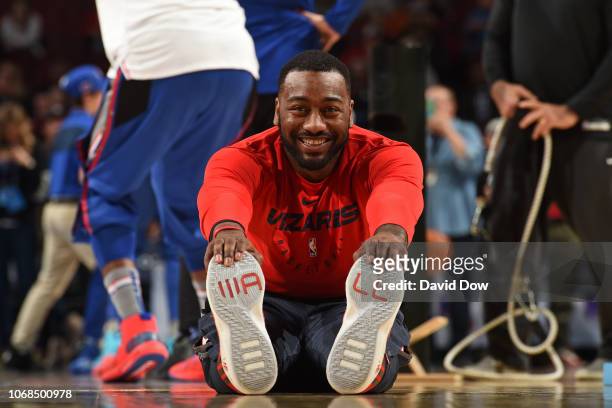 John Wall of the Washington Wizards smiles and stretches on the court before the game against the Philadelphia 76ers on November 30, 2018 at the...