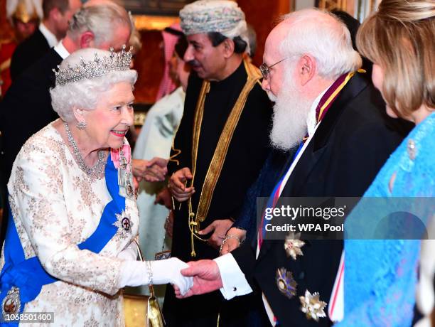 Queen Elizabeth II greets guests at an evening reception for members of the Diplomatic Corps at Buckingham Palace on December 04, 2018 in London,...