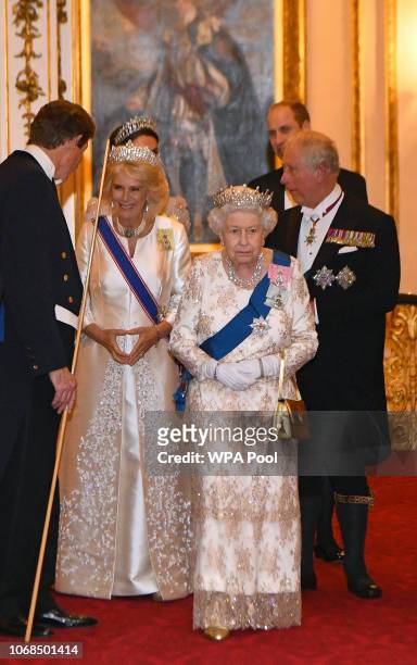 Queen Elizabeth II and Camilla, Duchess of Cornwall greet guests at an evening reception for members of the Diplomatic Corps at Buckingham Palace on...
