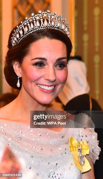 Catherine, Duchess of Cambridge greets guests at an evening reception for members of the Diplomatic Corps at Buckingham Palace on December 04, 2018...