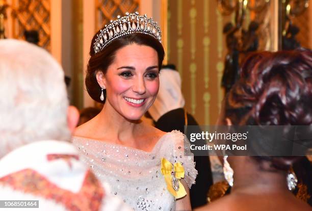 Catherine, Duchess of Cambridge greets guests at an evening reception for members of the Diplomatic Corps at Buckingham Palace on December 04, 2018...