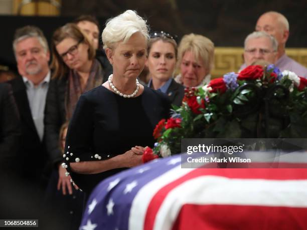 Cindy McCain pays her respects in front of the casket of the late former President George H.W. Bush as he lies in state in the U.S. Capitol Rotunda,...