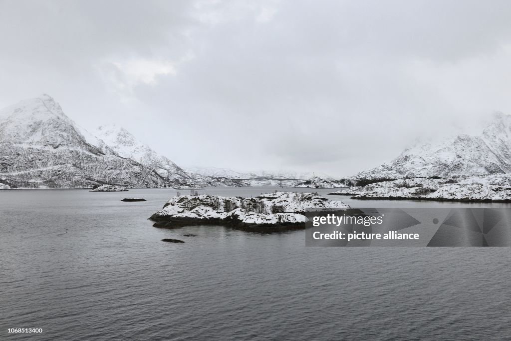 Grey cloudy Vesterålen winter landscape with the strait Raftsound and ...