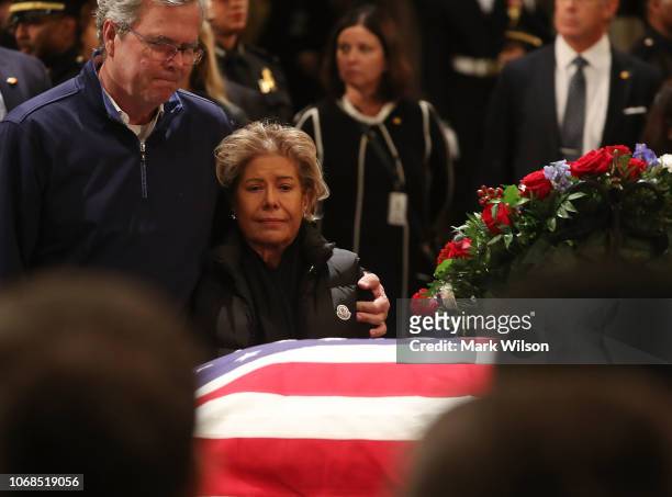 Jeb Bush and his wife Columba Bush pay their respects in front of the casket of the late former President George H.W. Bush as he lies in state in the...