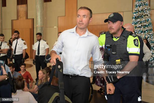 Protestors are removed by police during an anti Adani and climate change sit-in protest in the Marble Foyer at Parliament House on December 5, 2018...