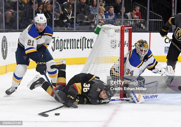 Tomas Hyka of the Vegas Golden Knights tries to control the puck after getting upended by Tyler Bozak of the St. Louis Blues as Jake Allen of the...
