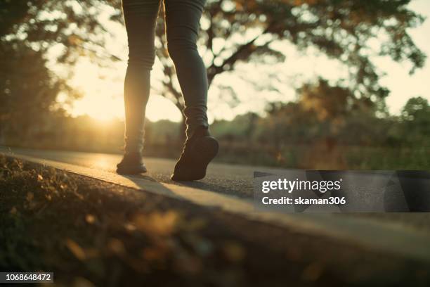 close up traveller foots walking on road - passenger train stockfoto's en -beelden