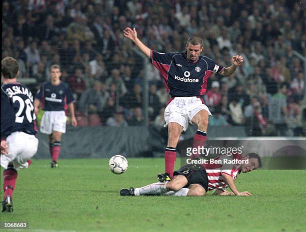 Mark Van Bommel of PSV Eindhoven slides into Roy Keane of Manchester United during the UEFA Champions League Group G match at the Philips Stadion, in...