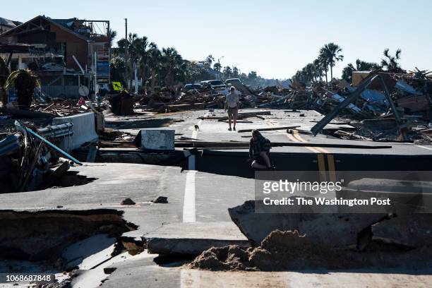Local residents make their way across a washed out road after category 4 Hurricane Michael made land fall along the Florida panhandle Wednesday, on...