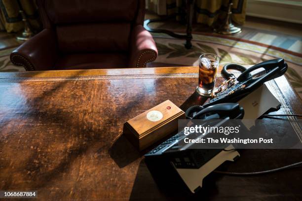 Glass of iced soda is seen on the Resolute Desk as President Donald Trump speaks during a meeting about the opportunity zones provided by tax reform...