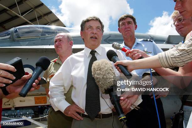 Australian Defence Minister Robert Hill speaks to the media in front of F/A 18 Hornet as General Peter Cosgrove and Air Marshall Angus Huston look on...