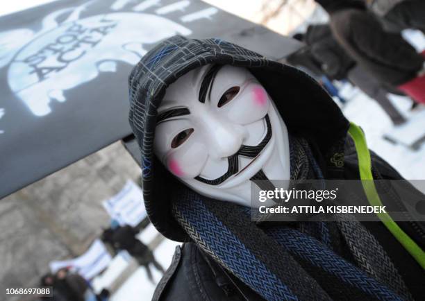 Protester wearing an Anonymous Guy Fawkes mask takes part in a demonstration against controversial Anti-Counterfeiting Trade Agreement as part of an...