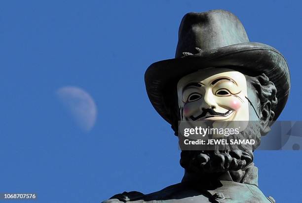 Half moon appears behind as a V for Vendetta Guy Fawkes mask is set on the statue of Civil War Gen. James B. McPherson at the McPherson Square by...