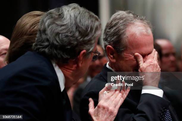 Former President George W. Bush, right, cries after speaking during the state funeral for his father, former President George H.W. Bush, at the...