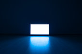 The television on a floor with a blue light background