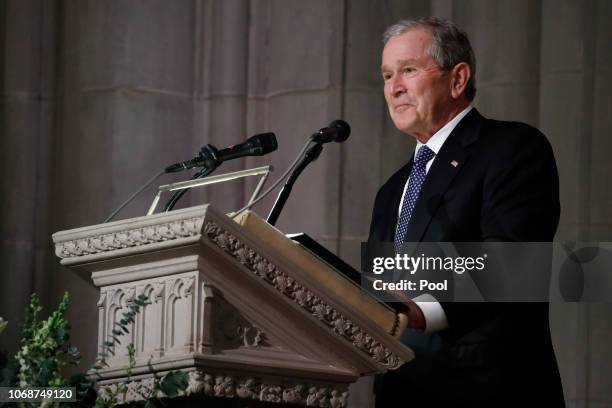 Former President George W. Bush pauses as speaks at the state funeral for his father, former President George H.W. Bush, at the Washington National...