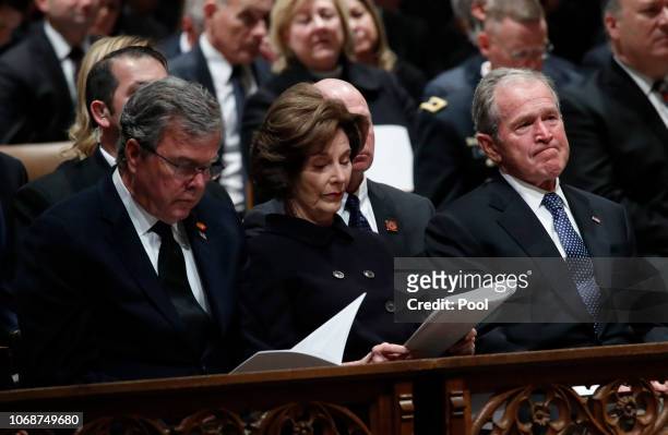 Former President George W. Bush, right, former first lady Laura Bush and former Florida Gov. Jeb Bush attend the State Funeral for former President...
