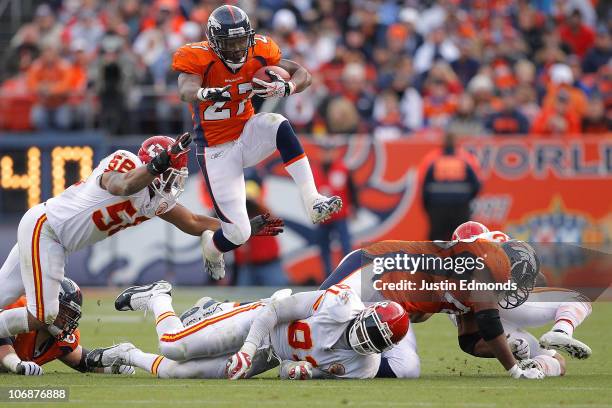 Running back Knowshon Moreno of the Denver Broncos jumps over a pile of defenders and past linebacker Derrick Johnson of the Kansas City Chiefs...