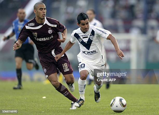 Velez Sarsfield's midfielder Maximiliano Moralez vies for the ball with midfielder Guido Pizarro of Lanus, during their Argentina first division...