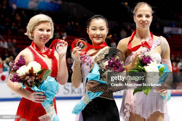 Rachael Flatt, Kanako Murakami of Japan and Carolina Kostner of Italy pose for photographers after the Ladies competition during Skate America at...