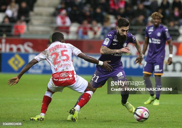 Reims' Malian midfielder Moussa Doumbia vies for the ball with Toulouse's Swedish midfielder Jimmy Durmaz during the French L1 football match between...