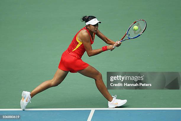 Shuai Peng of China plays a backhand in the Women's Team Doubles Tennis Semifinal match against Nudnida Luangnam and Varatchaya Wonteanchai of...