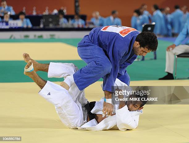 Kuwait's Elish Kh Y Y A Alali fights Iran's Arash Miresmaeili in the men's -66kg category of judo at the 16th Asian Games in Guangzhou on November...