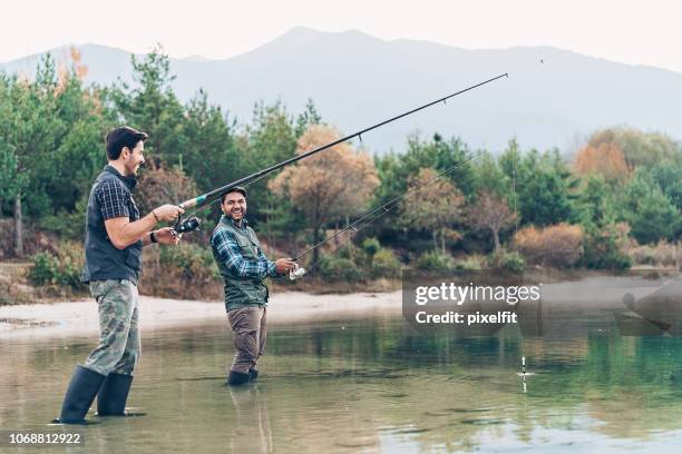 smiling fishermen - freshwater fishing stock pictures, royalty-free photos & images