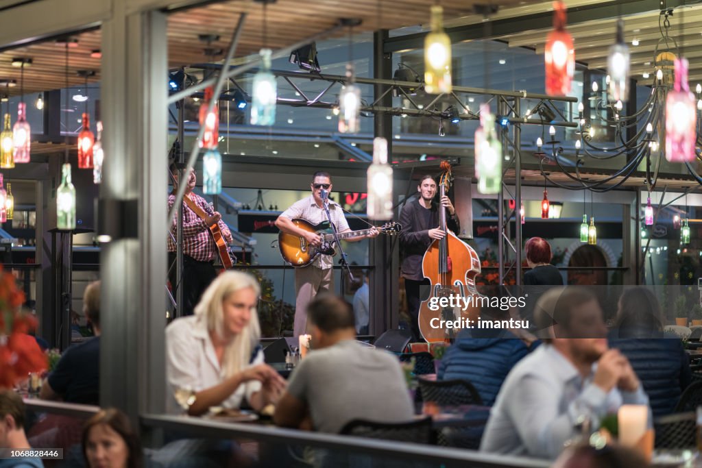 Musicians playing in an outdoor cafe.
