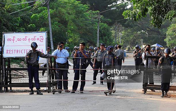 Policemen man a check-point set up across the road leading to Myanmar's opposition leader Aung San Suu Kyi's house in Yangon on November 13, 2010....