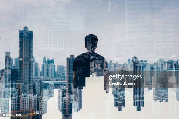 double exposure of rear view smart young man against aerial view of hong kong city skyline - über etwas schauen stock-fotos und bilder