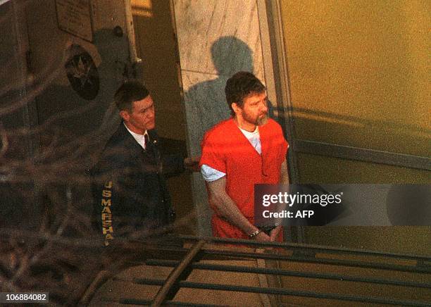 Unabomber suspect Theodore Kaczynski is lead out the Federal Courthouse by a US Marshal after a hearing to determine his competency 20 January in...