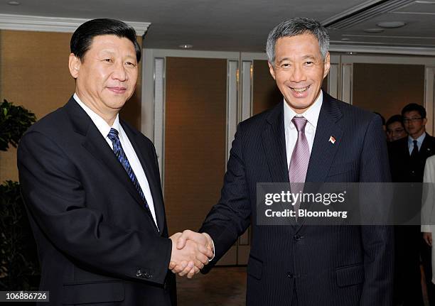 Xi Jinping, China's vice president, left, shakes hands with Lee Hsien Loong, Singapore's prime minister, at the Shangri-La Hotel in Singapore, on...