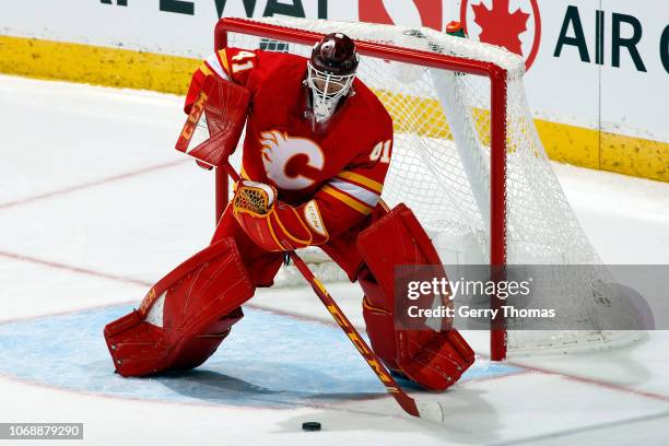 Calgary Flames Goalie Mike Smith plays the puck against the Montreal Canadiens during an NHL game on November 15, 2018 at the Scotiabank Saddledome...
