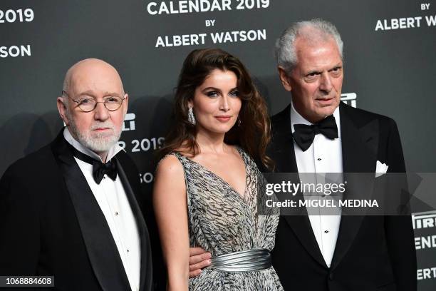 Scottish photographer Albert Watson , French actress and model Laetitia Casta and Pirelli's CEO Marco Tronchetti Provera pose on the red carpet upon...