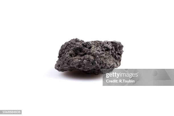 black lava rock from volcano on a white background - lava stone stock pictures, royalty-free photos & images