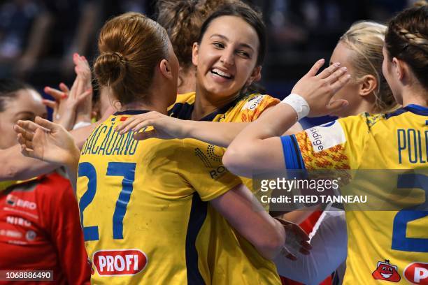 Romania's players celebrate their victory at the end of the Women Euro 2018 handball Championships group D preliminary round match between Norway and...