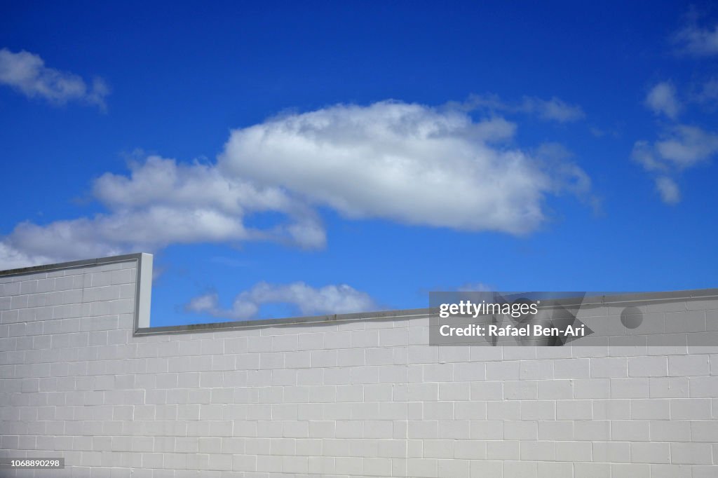 White Brick Wall Under White Clouds