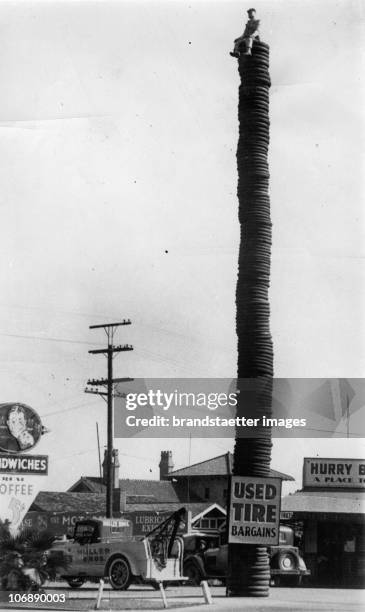 Record bracking stack of tyres is used as as advertisement at Hollywood, California. To attract attention to a large stock of used tyres two salesman...