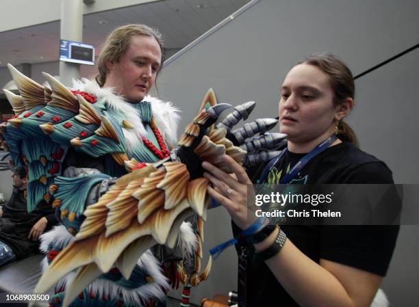 Jason Foster of Auburn, AL dressed as a Zinogre from the game Monster Hunter World gets assistance from his wife Amanda during DreamHack Atlanta 2018...