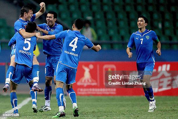 Nagaev Ivan of Uzbekistan and team members celebrate after scoring in the 1/8 final at University Town Main Stadium during day three of the 16th...