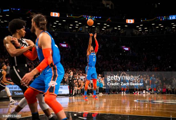 Paul George of the Oklahoma City Thunder shoots a three pointer game winning shot against the Brooklyn Nets late in the fourth quarter on December 5,...