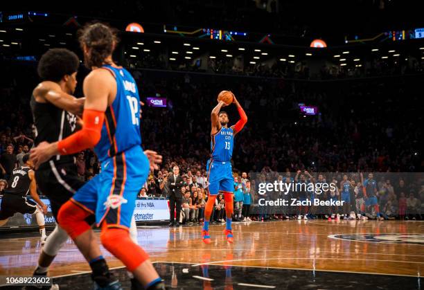 Paul George of the Oklahoma City Thunder shoots a three pointer game winning shot against the Brooklyn Nets late in the fourth quarter on December 5,...