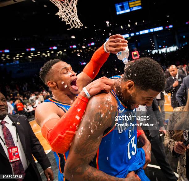 Russell Westbrook of the Oklahoma City Thunder covers Paul George of the Oklahoma City Thunder with water after George hits a three pointer in the...