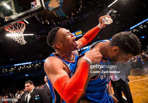 Russell Westbrook of the Oklahoma City Thunder covers Paul George of the Oklahoma City Thunder with water after George hits a three pointer in the...