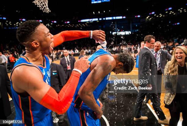 Russell Westbrook of the Oklahoma City Thunder covers Paul George of the Oklahoma City Thunder with water after George hits a three pointer in the...